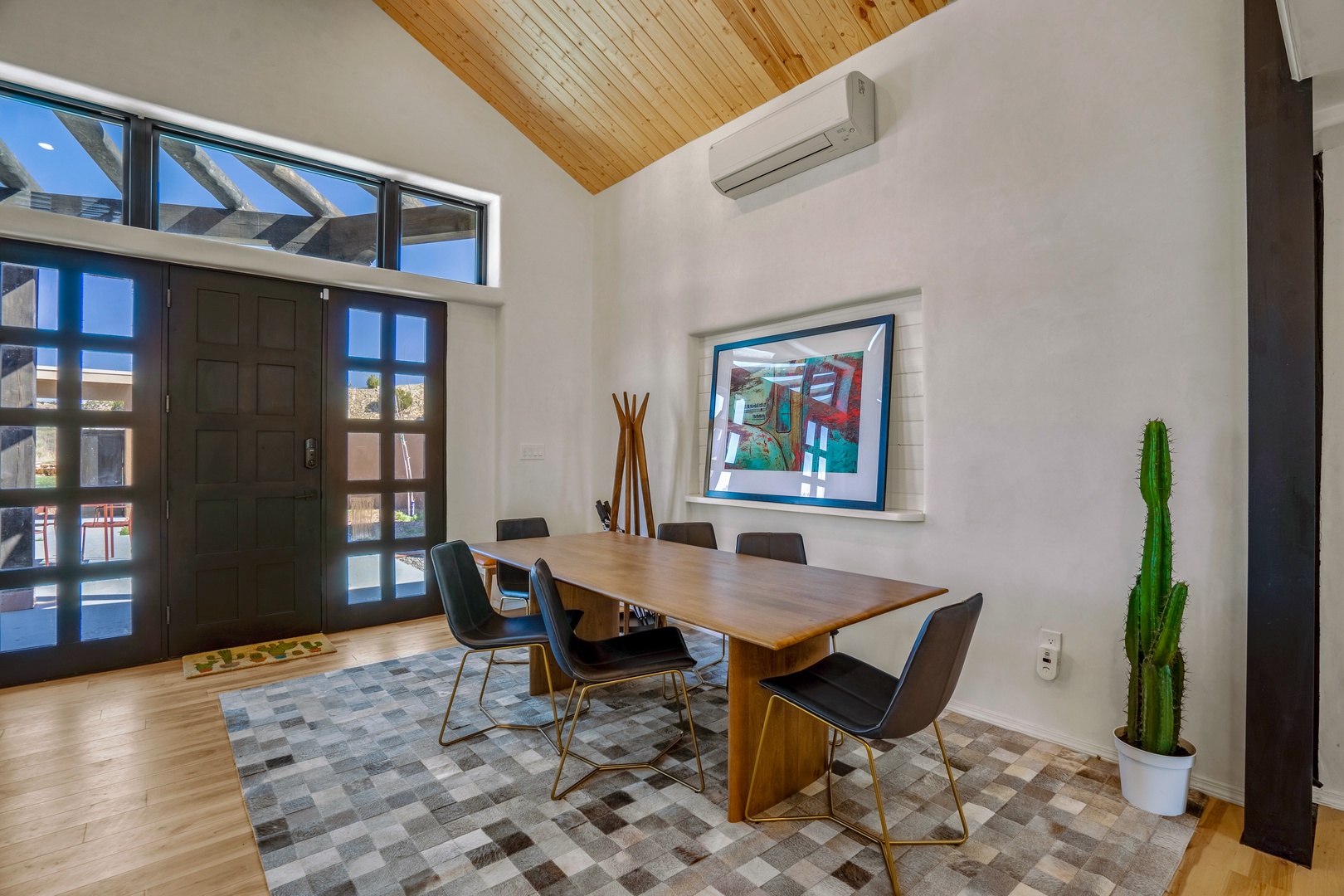 Your stylish dining space features warm wood and modern touches, perfect for memorable meals together under soaring ceilings.