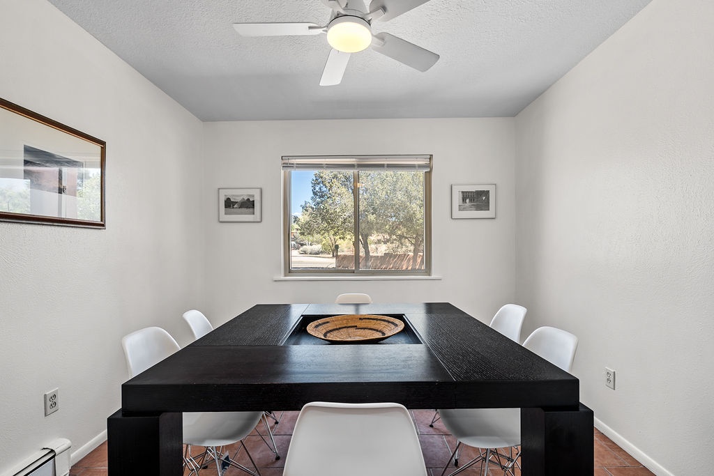 Your modern dining space features a sleek table for six with natural desert views through the window.