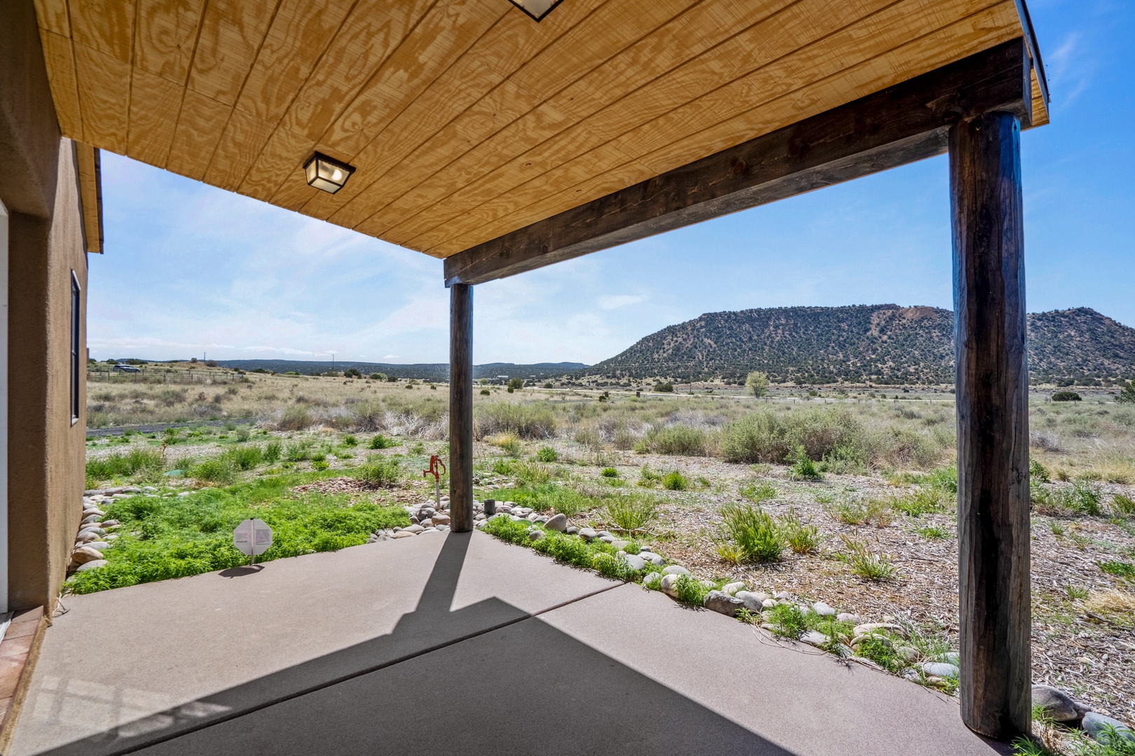 Covered porch with stunning mountain views and open desert landscapes stretching toward the horizon.