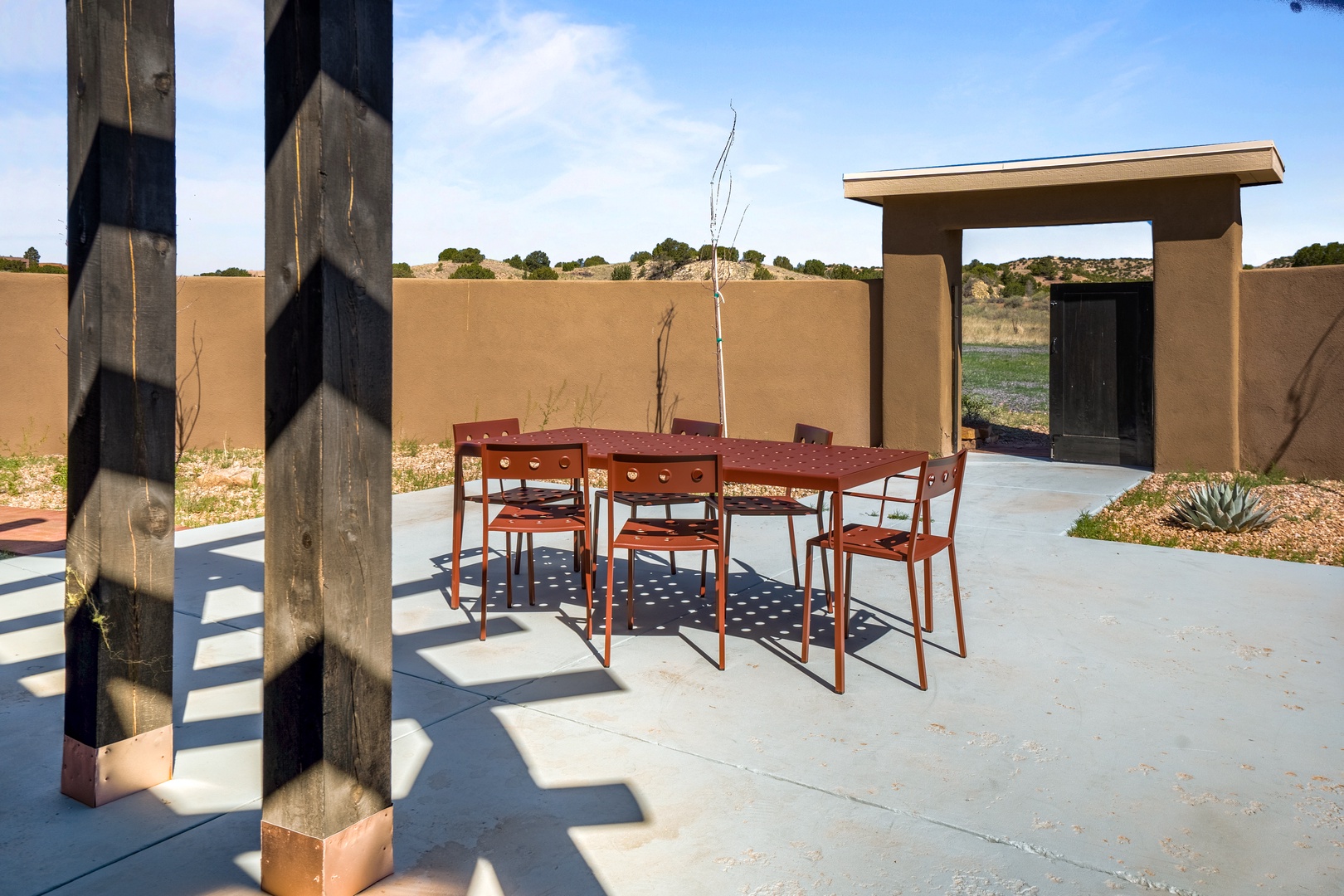 Gather around your private outdoor dining table on this spacious concrete patio, where desert views and modern design create the perfect backdrop for memorable meals.