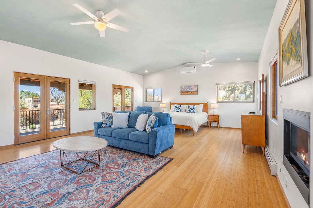 Your spacious suite blends comfort and style with a cozy fireplace, plush seating, and French doors opening to your private balcony.