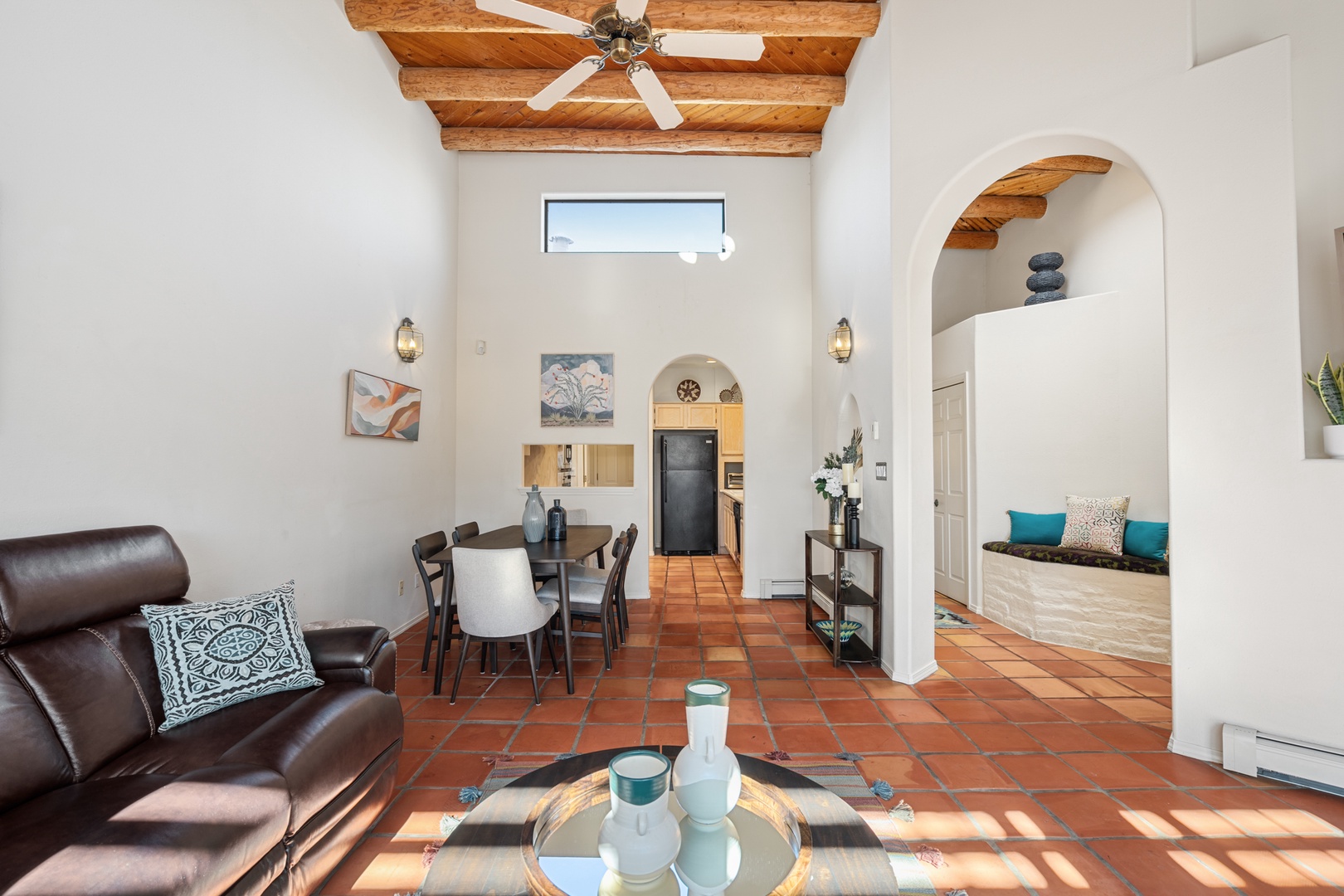 Relax in your beautifully designed living space featuring rustic wood beam ceilings, comfortable leather seating, and charming terra cotta floors that flow throughout your home.
