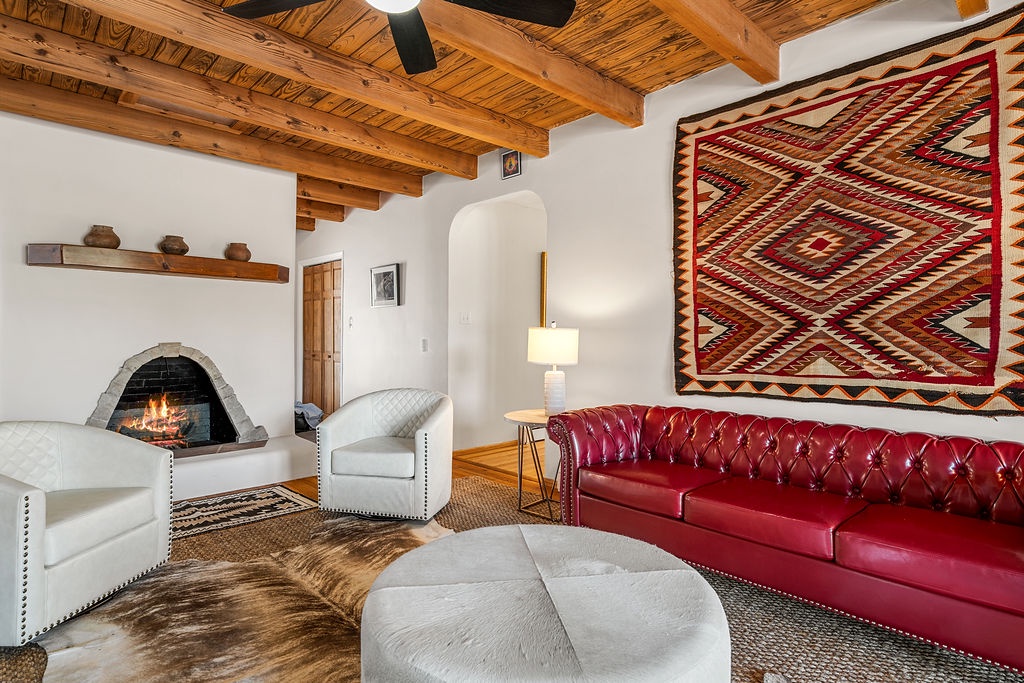 Cozy up by your crackling fireplace in this stunning living room where rich leather and vibrant textiles create the perfect retreat.