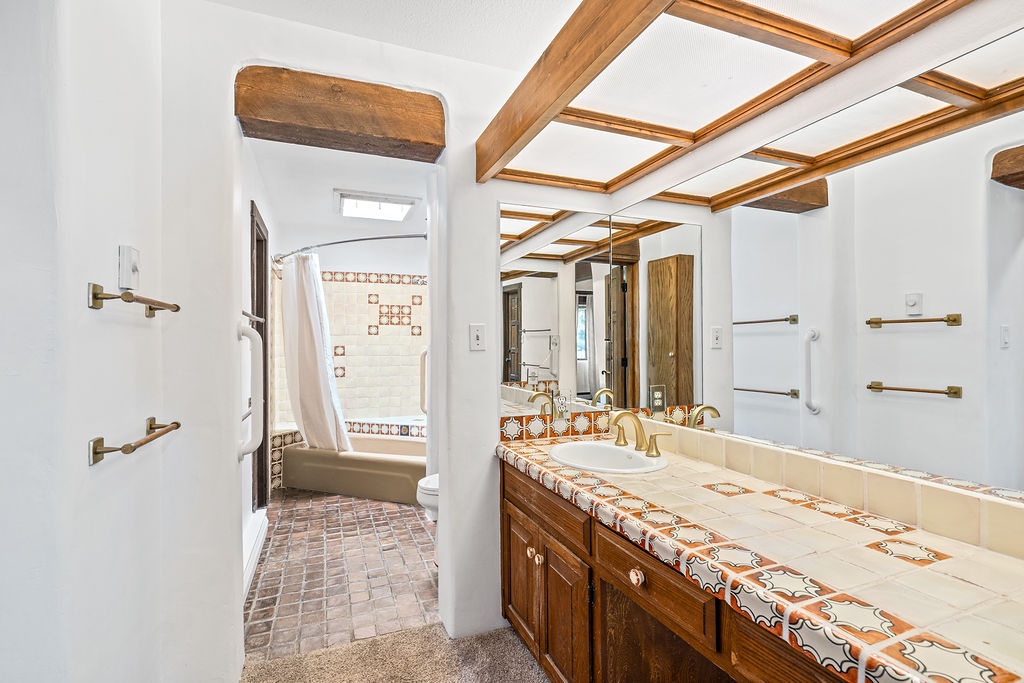 Your spacious bathroom features rustic wood beams, colorful tile accents, and dual vanities for relaxing morning routines.