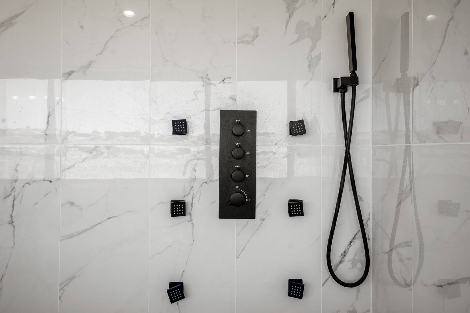 Unwind in your luxury marble shower with multiple body jets and handheld controls for a spa-like experience.