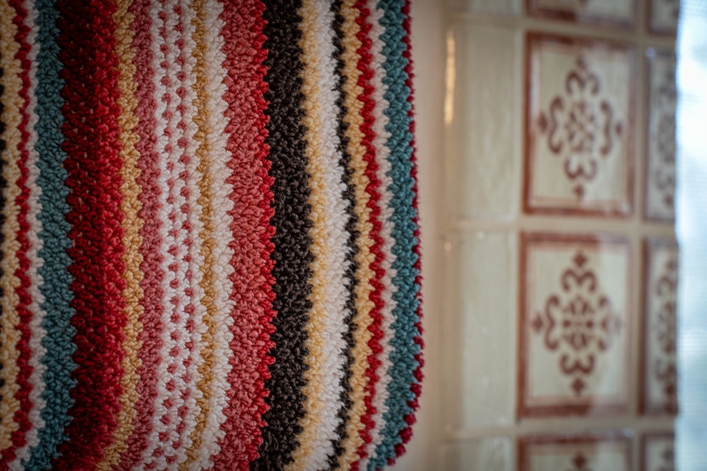 Sink into the rich textures and vibrant colors that welcome you into this thoughtfully decorated space.