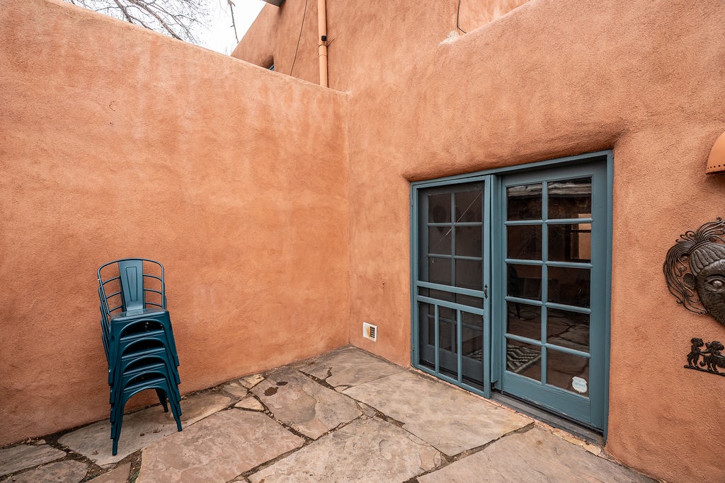 Step onto your private patio with charming southwestern architecture and turquoise accents that frame peaceful moments outdoors.