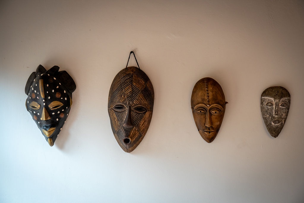 Four stunning African masks create an artful gallery wall, adding cultural warmth and character to your living space.