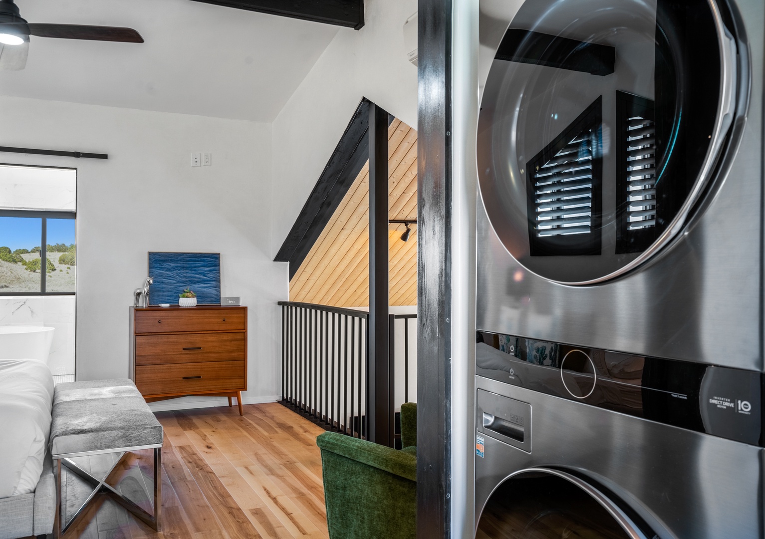 Your laundry needs are covered with this sleek stacked washer-dryer unit, perfectly integrated into your stylish living space.