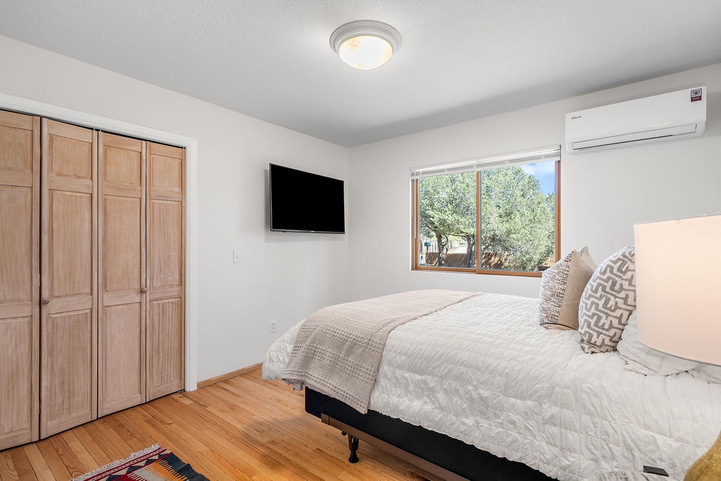 Relax in this bright bedroom with crisp linens, warm hardwood floors, and ample closet space for your belongings.
