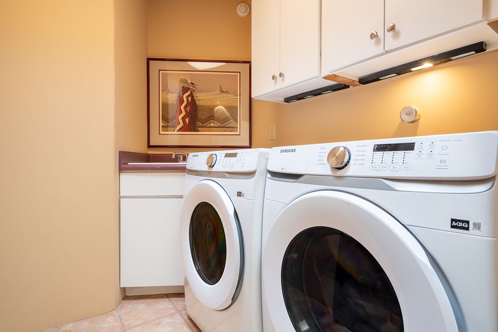 Your dedicated laundry room features modern washer and dryer with stylish cabinetry, making longer stays effortless and convenient.