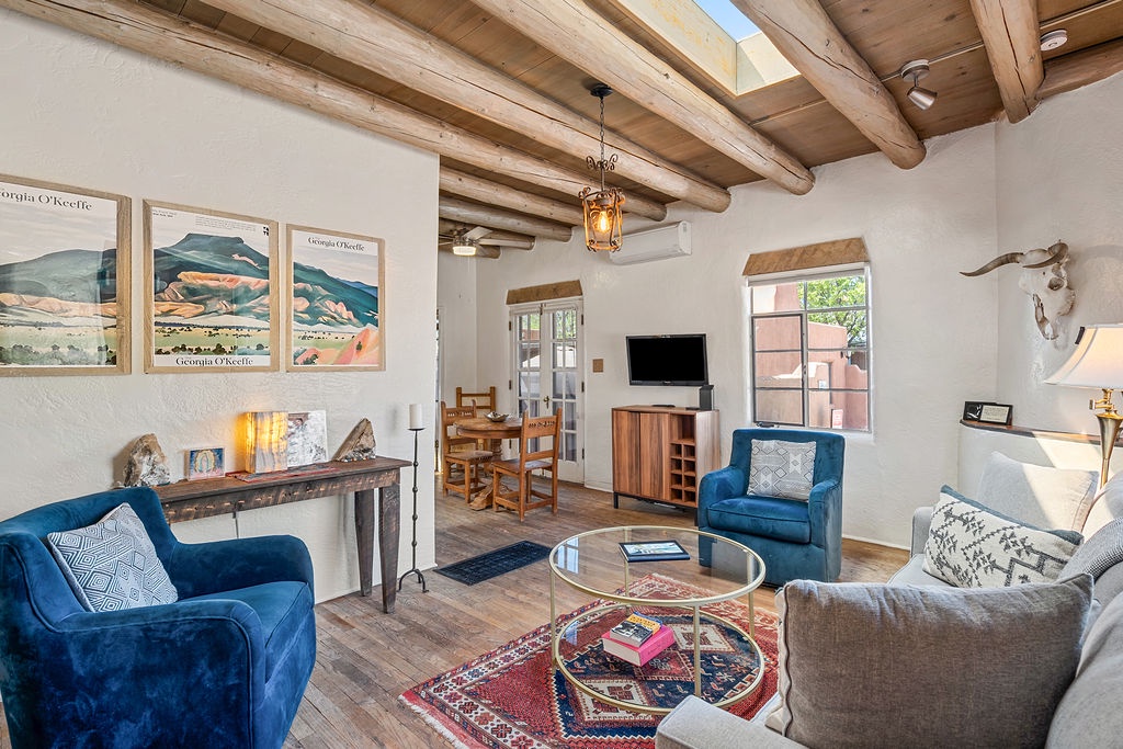 Your rustic-chic living room combines exposed beams with plush seating, where you'll unwind with local art adorning the walls.