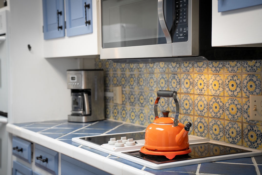 Your bright kitchen awaits with charming tile backsplash and modern appliances for easy meal preparation during your stay.