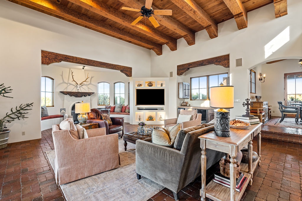 Unwind in your stunning living room where exposed beams, cozy seating, and warm lighting create the perfect retreat for relaxation.
