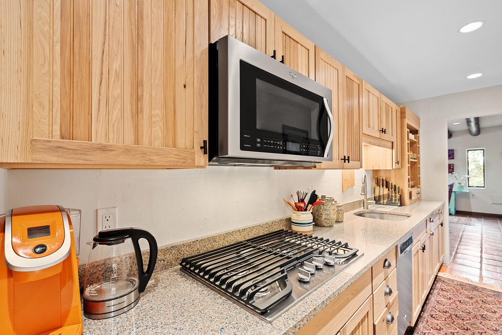 Your fully equipped kitchen features warm wood cabinets, granite counters, and modern appliances to make every meal feel special.