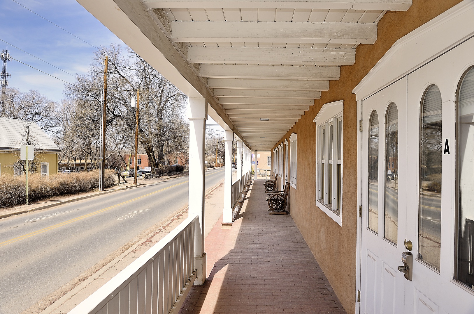 Covered walkway with classic southwestern architecture overlooking the quiet street and surrounding neighborhood.