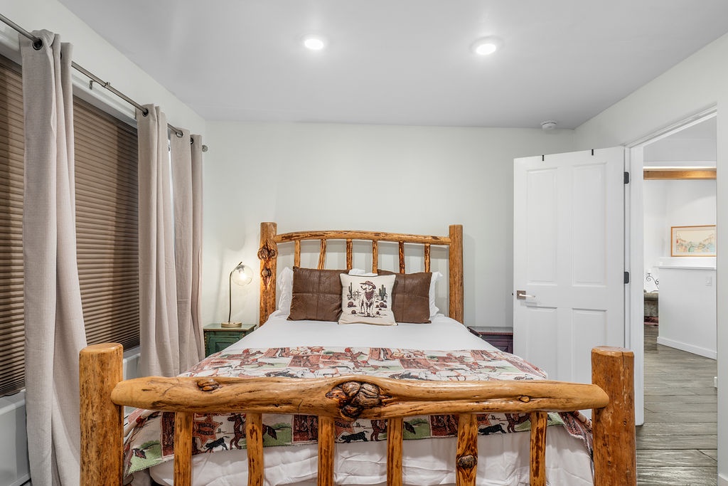 Your cozy bedroom features a rustic log bed with western-themed linens, creating a charming retreat for peaceful nights.