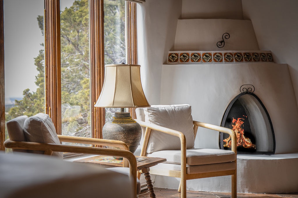 Cozy up by the crackling fireplace in your bright reading nook, where warm wood tones and plush seating create the perfect spot for relaxation.