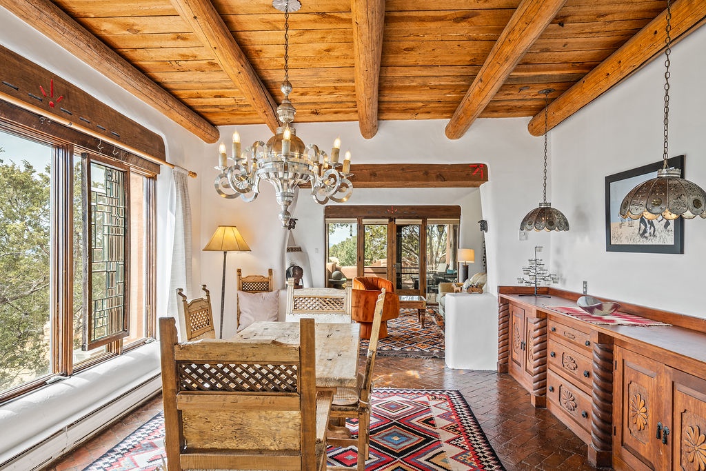 Step into your charming retreat where rustic wood beams frame soaring ceilings and southwestern warmth welcomes you home.