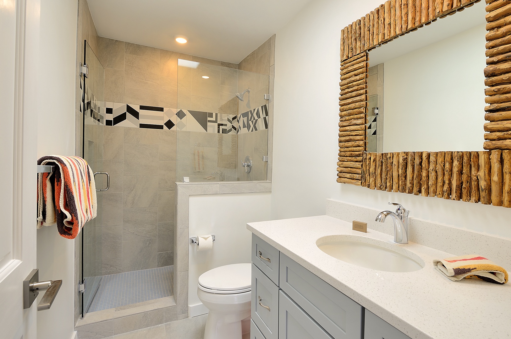 Unwind in your spa-like bathroom featuring a spacious walk-in shower and elegant vanity with rustic mirror accents.
