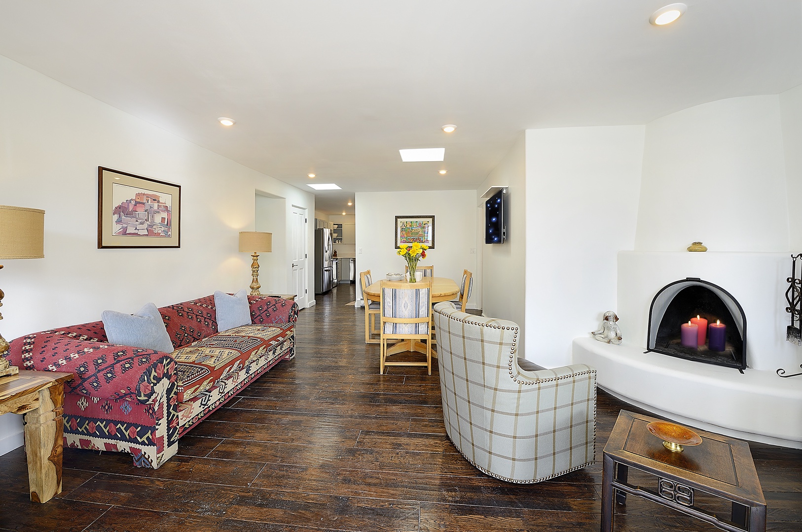 Unwind in your stylish living space with cozy fireplace, vibrant textiles, and thoughtful touches that make you feel instantly at home.