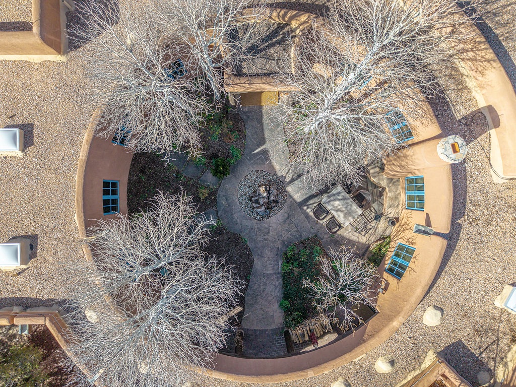 Aerial view of southwestern-style property featuring curved architecture and central courtyard with outdoor gathering spaces.