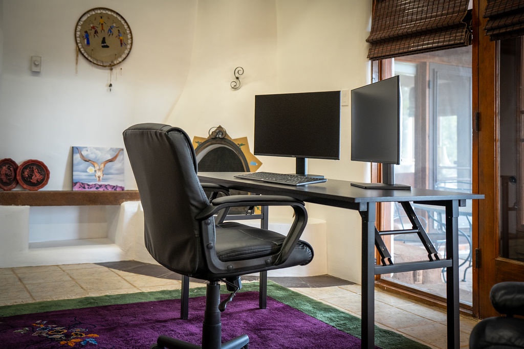 Your dedicated workspace awaits with dual monitors and ergonomic seating, perfect for productive remote work sessions in comfort.