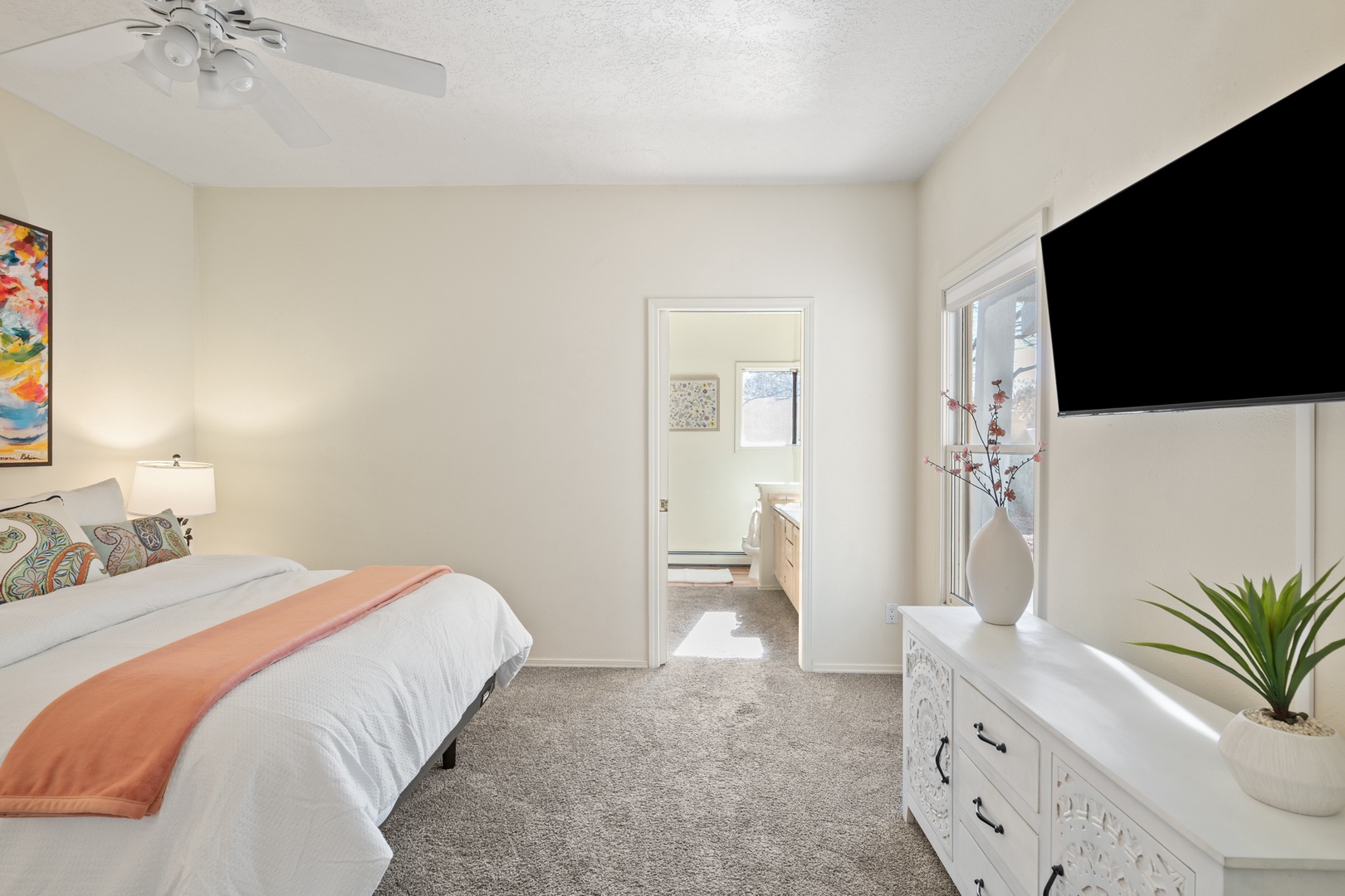 Your peaceful bedroom features a comfortable bed, modern TV, and stylish decor to ensure a restful stay.