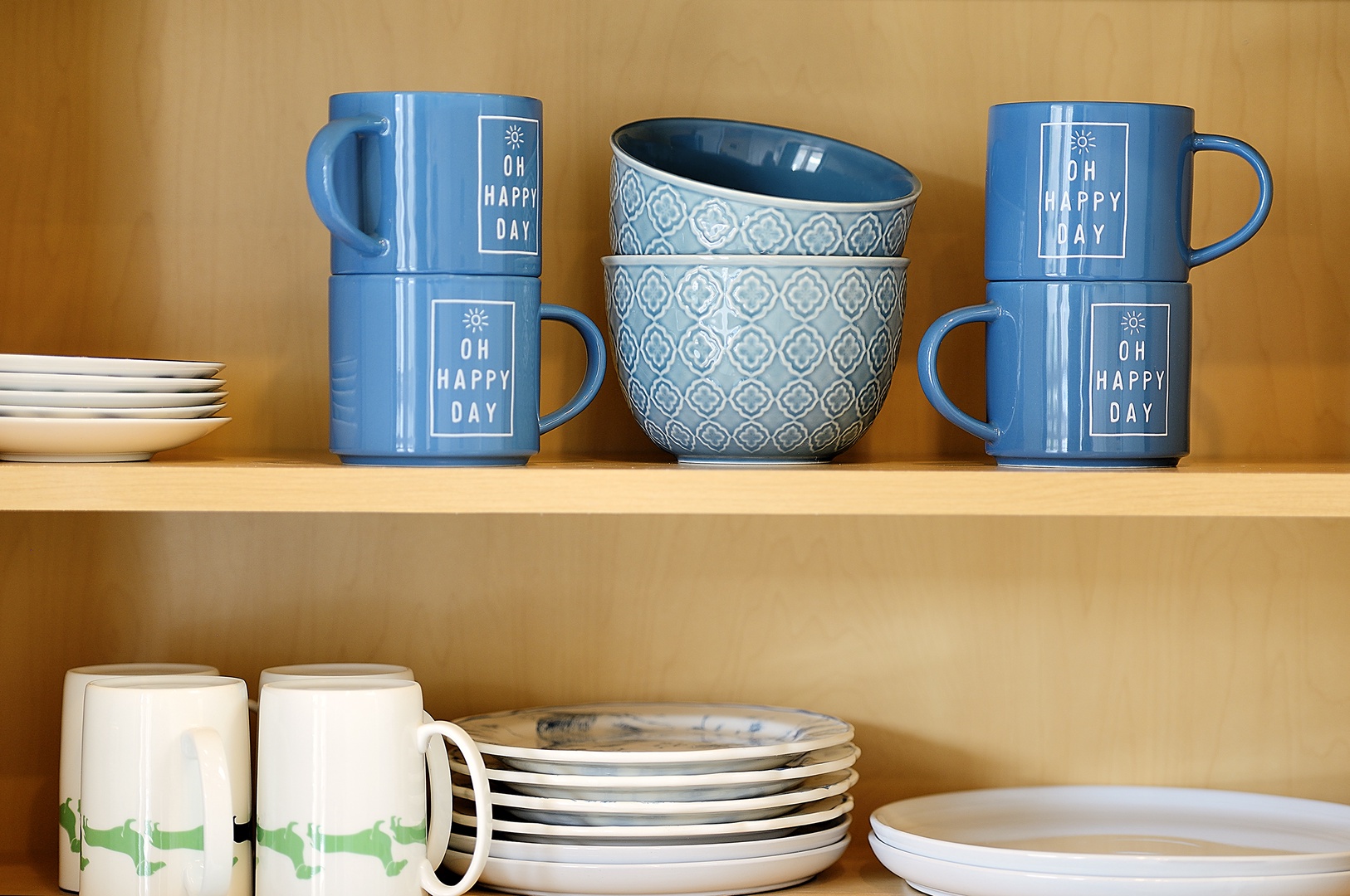 Your kitchen comes stocked with cheerful mugs and dinnerware, making morning coffee feel extra special.