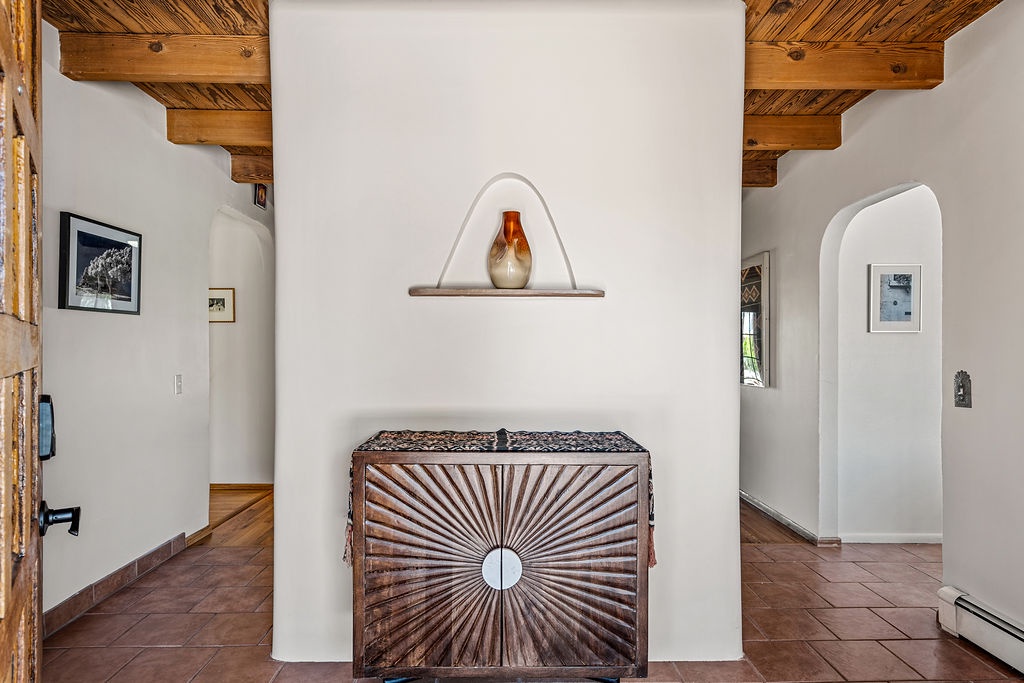 Unwind in this elegant Southwestern sanctuary where rustic wooden beams frame your peaceful retreat space.