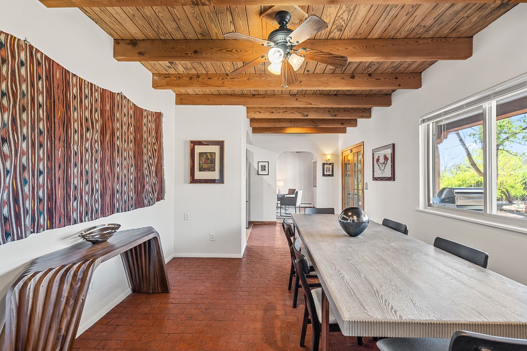 Your dining room blends rustic charm with modern comfort, featuring exposed wood beams and artistic touches for memorable meals.