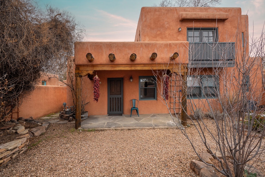 Classic adobe architecture with traditional Southwest charm and peaceful desert landscaping creates an authentic regional experience.