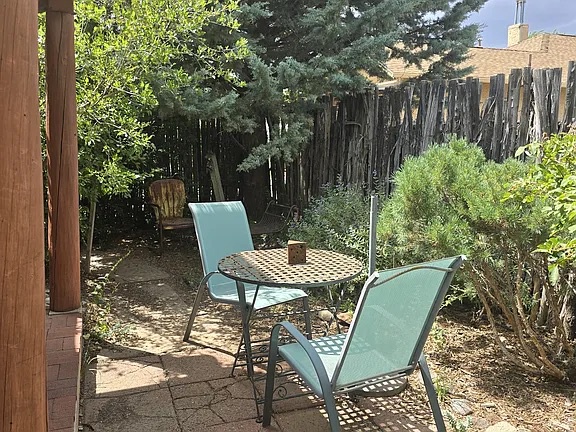 Relax at your private outdoor table surrounded by fragrant pines and native plants, perfect for morning coffee or unwinding after a day of exploring the area.