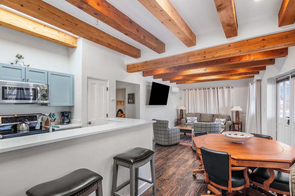 Relax in this stunning open-concept space where exposed wooden beams frame your mountain getaway perfectly.