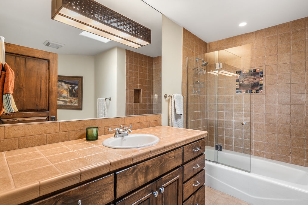 Unwind in your spacious bathroom with warm tile accents, perfect for relaxing soaks after mountain adventures.