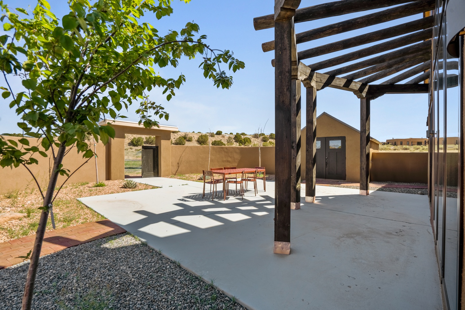 Modern desert retreat with covered patio featuring clean lines and natural materials in a peaceful southwestern setting.