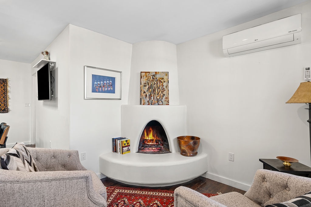 Curl up in your cozy living room where a crackling corner fireplace creates the perfect ambiance for relaxing evenings.