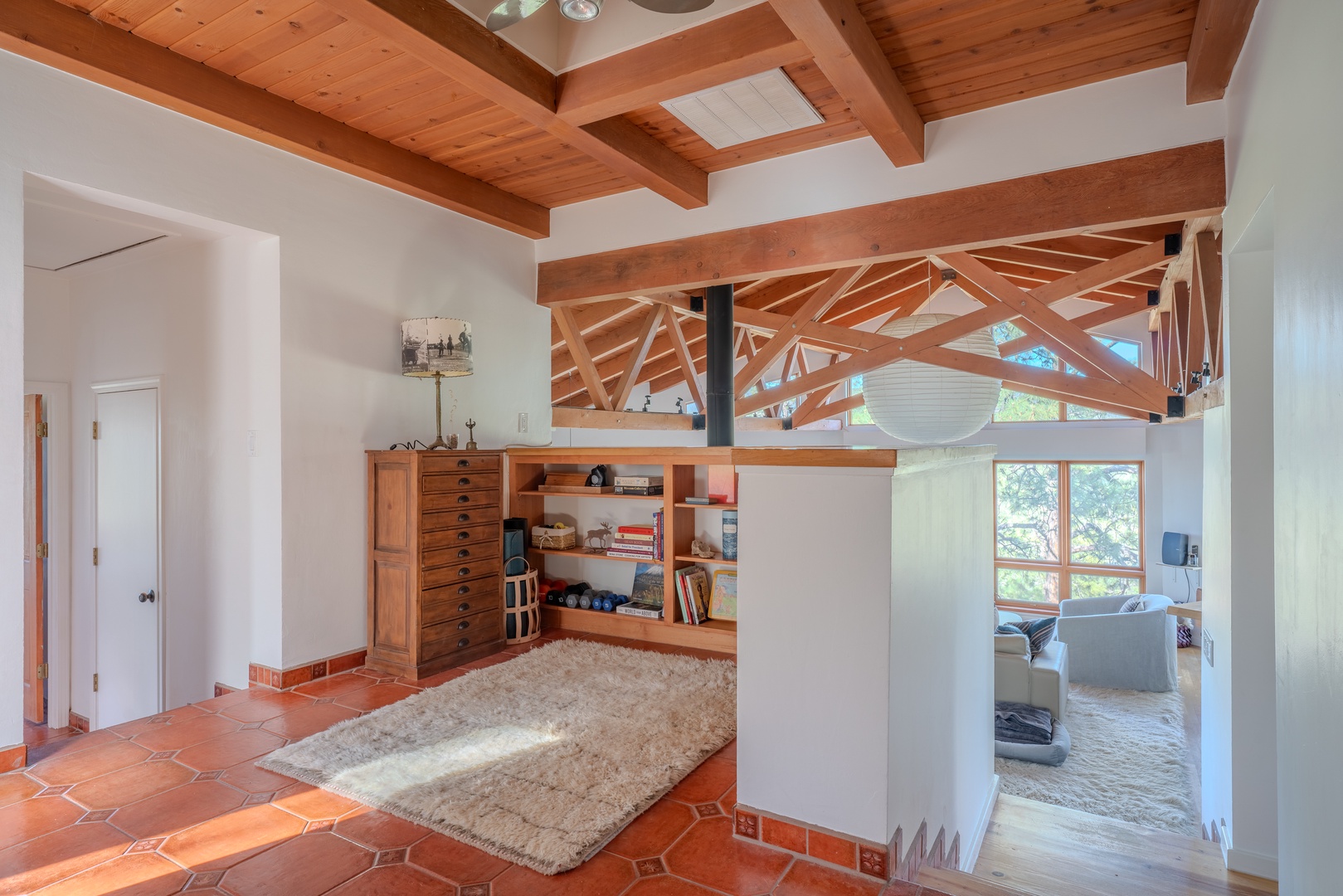 Stunning architectural details meet comfort in your private space—vaulted beamed ceilings, warm wood tones, and natural light invite you to settle in and unwind.