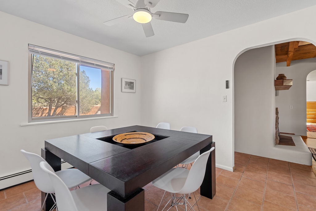 Gather around this sleek dining table where your meals become memorable moments, with garden views creating a peaceful backdrop for your conversations.