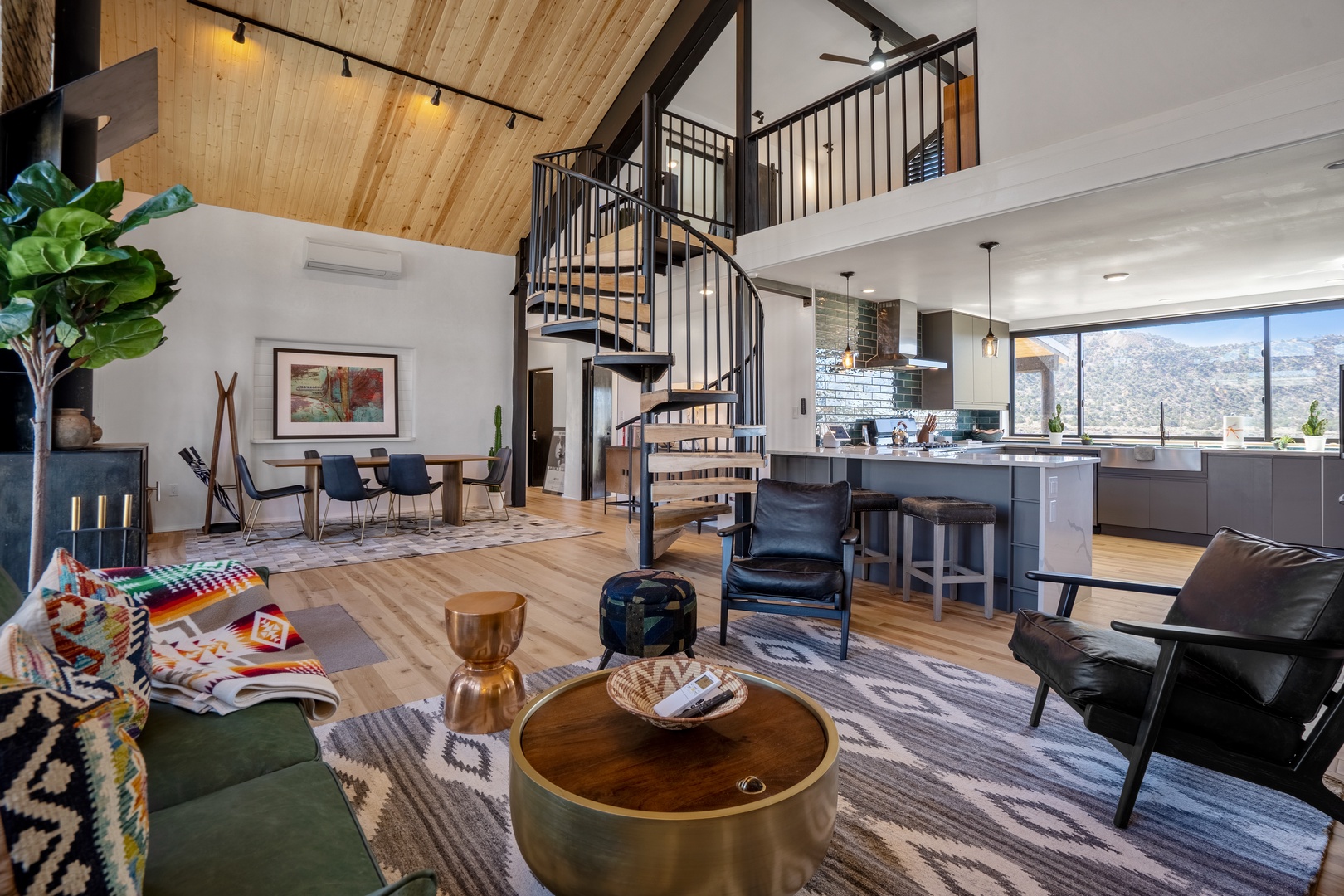 Relax in your stunning open-concept retreat with soaring wood ceilings, spiral stairs, and mountain views from the chef's kitchen.