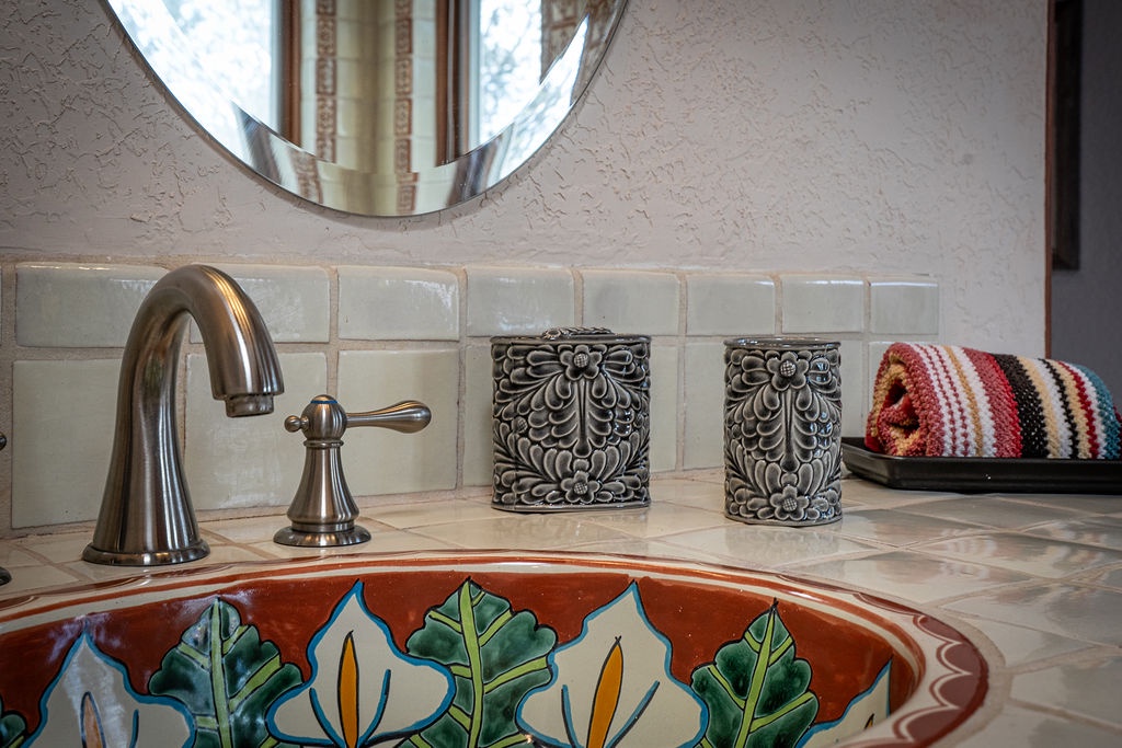 Refresh at your hand-painted ceramic sink with intricate leaf motifs, brushed gold fixtures, and artisan touches that make every morning feel special.