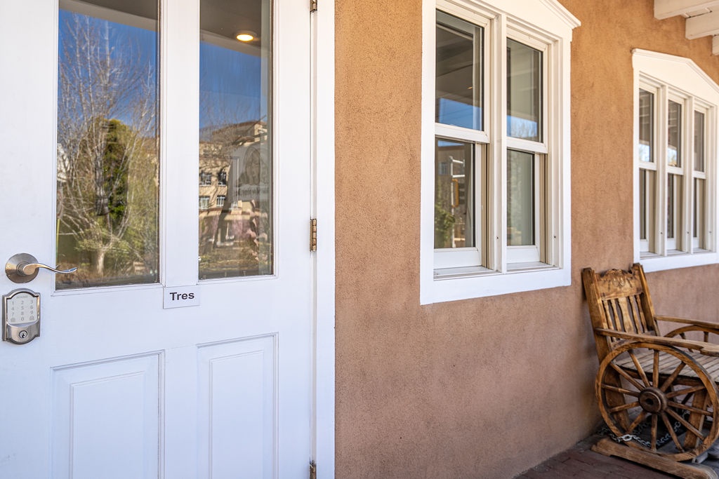Charming adobe-style entrance with southwestern décor welcomes guests to this distinctive vacation rental property.
