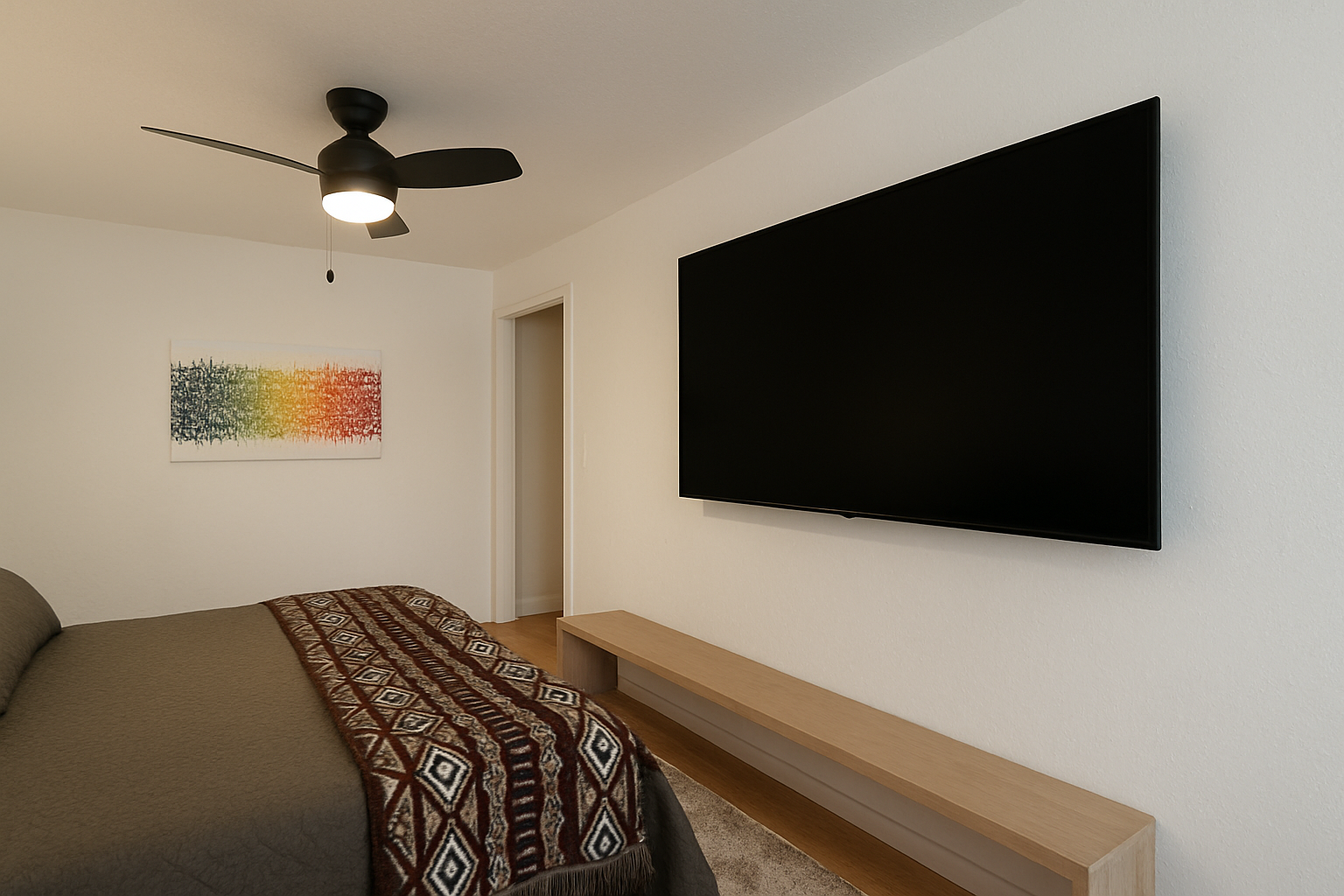 Unwind in your modern bedroom with a large wall-mounted TV for entertainment and a sleek ceiling fan to keep you comfortable during your stay.