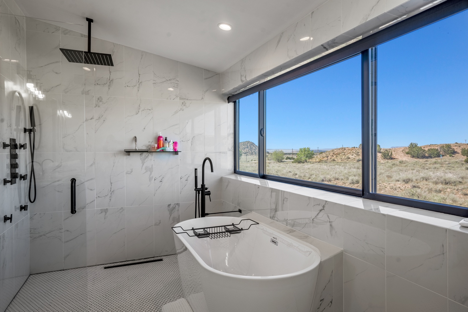 Soak in your elegant marble bathroom while gazing at stunning desert landscapes through floor-to-ceiling windows.