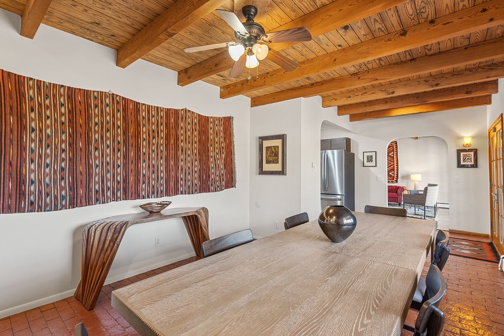 Gather around your striking dining table beneath stunning exposed wood beams and vibrant Native American textiles.
