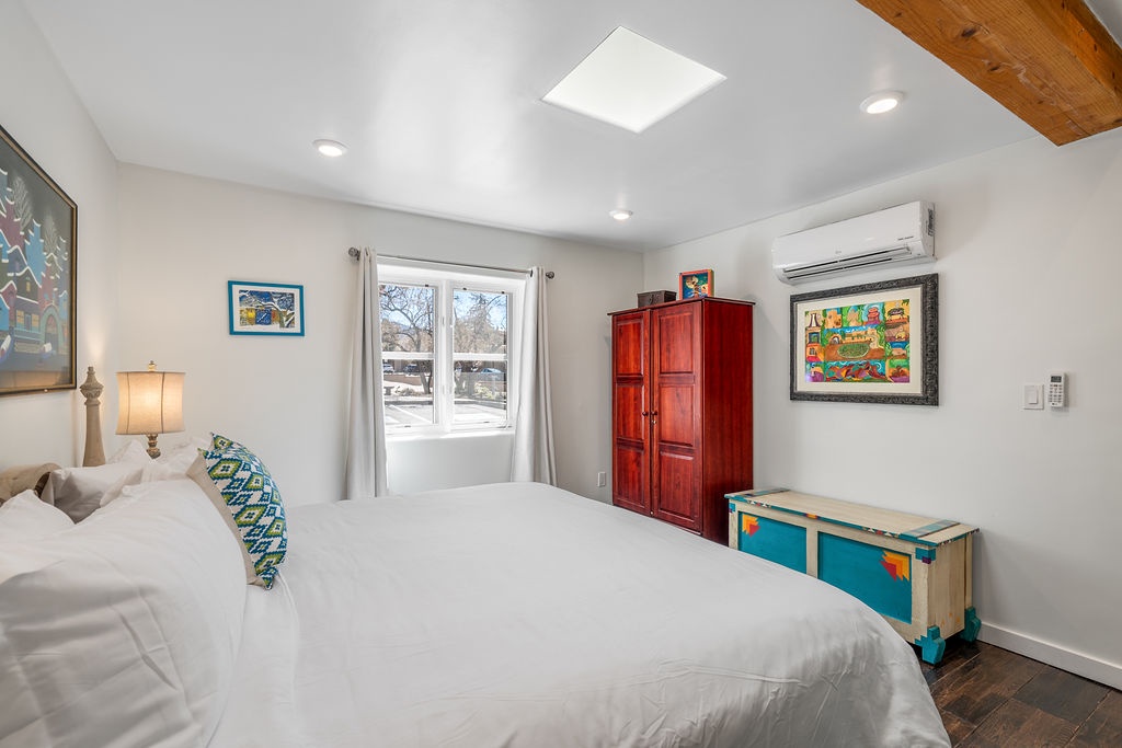 Relax in your bright bedroom with artwork, exposed beam ceiling, and crisp linens waiting for your perfect night's rest.