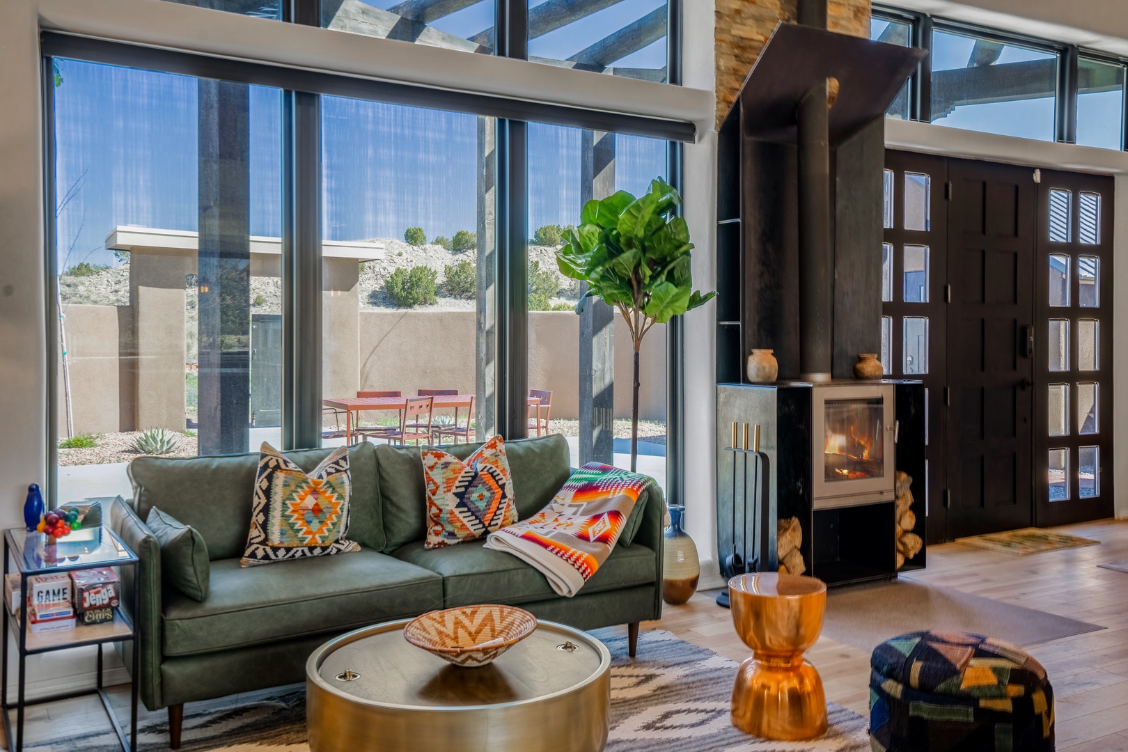 Sink into your cozy living space where southwestern-style pillows complement the warmth of your crackling fireplace and desert views.