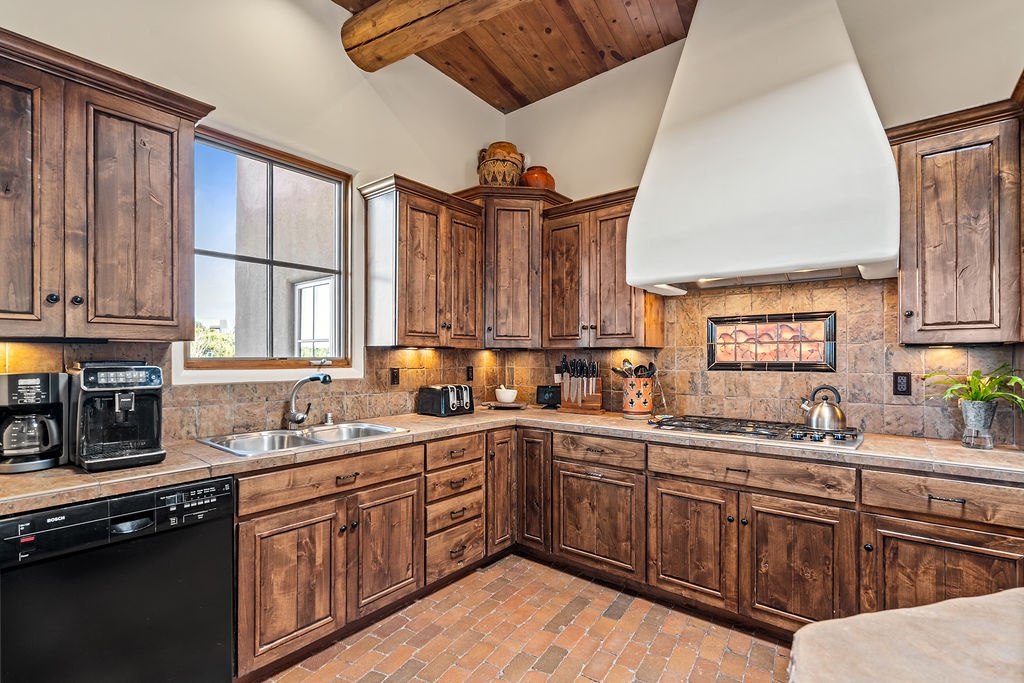 Your spacious kitchen features rich wood cabinetry and stone countertops, perfect for preparing memorable meals during your stay.