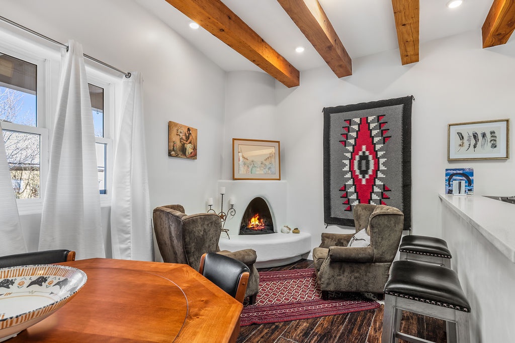 Cozy up by the crackling fireplace in your southwestern-style living room, complete with exposed beams and local art.