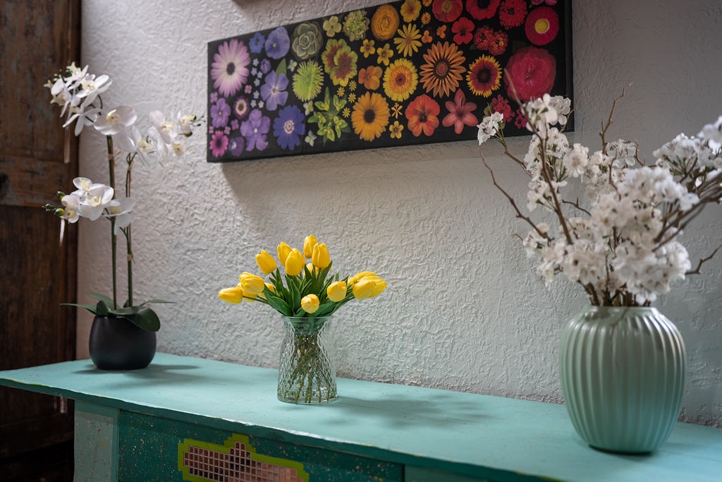 Brighten your mornings with cheerful yellow tulips and elegant orchids adorning your stylish living space.